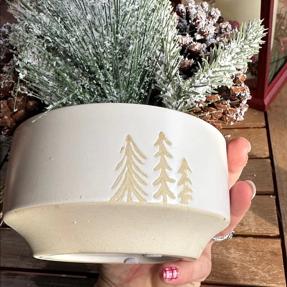 faux winter greenery in a pine tree ceramic bowl